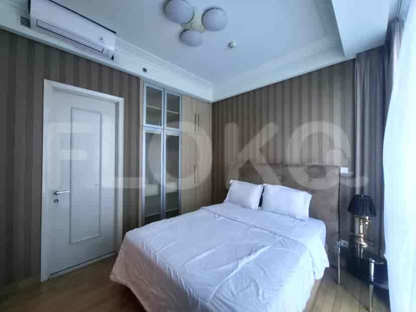 A bedroom with a large bed, closet and decorative design.