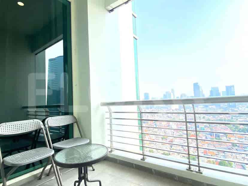 Balcony with chairs and a view.