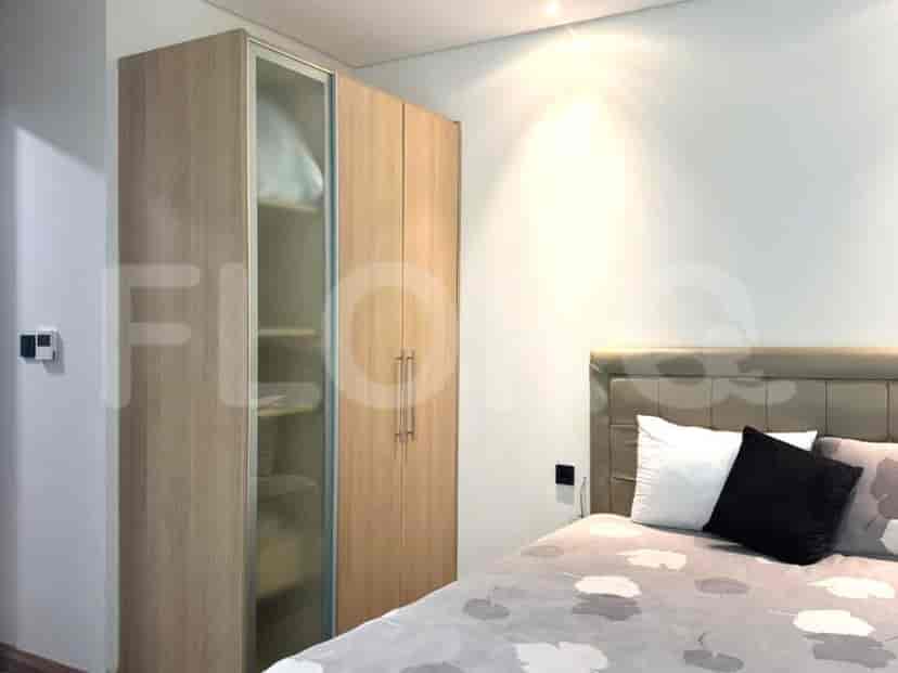 Bedroom with a wardrobe and closet with mirrors.