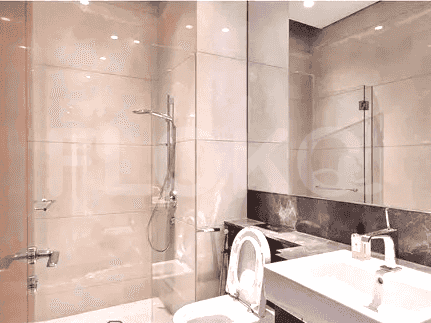 Bathroom with glass shower and toilet.