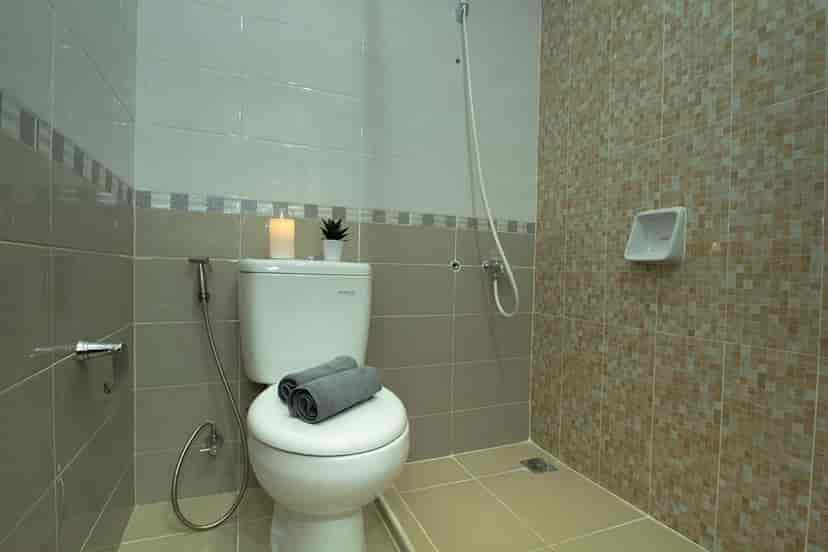 A clean bathroom with a toilet and shower setup.