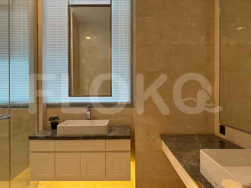 A modern bathroom with a large mirror and a sink.