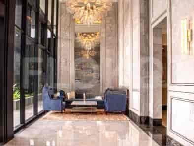 Luxurious lobby with marble walls and a large chandelier.