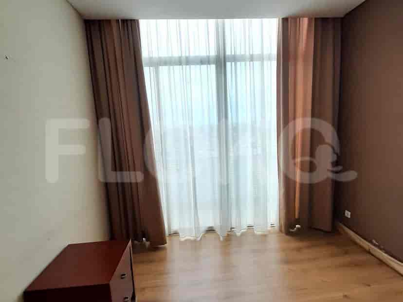 The bedroom has dark curtains and a view of a window.