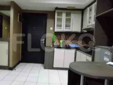 Compact kitchen with essential appliances and cabinets.
