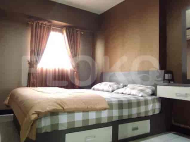 Bedroom with a bed and curtains.