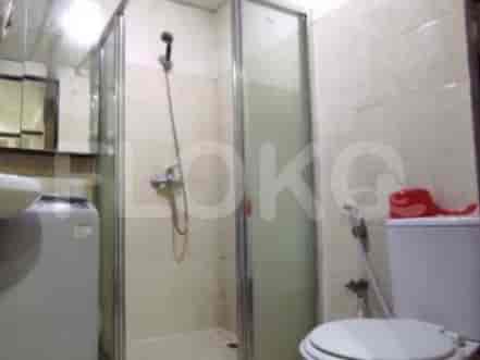 Compact bathroom with shower and toilet.