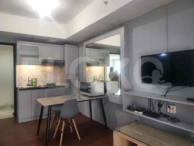 Modern kitchen with cabinets, appliances, and a dining table.