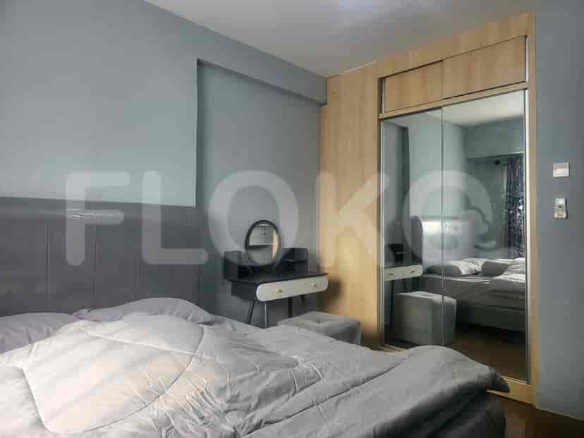 Bedroom with a bed, wardrobe, and vanity.