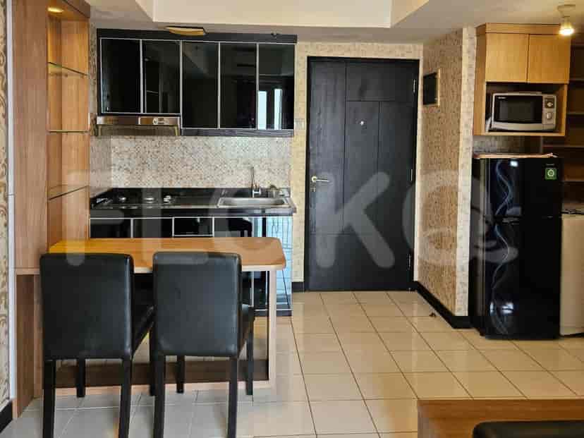 Modern kitchen with black cabinets, a stove, and a dining area.