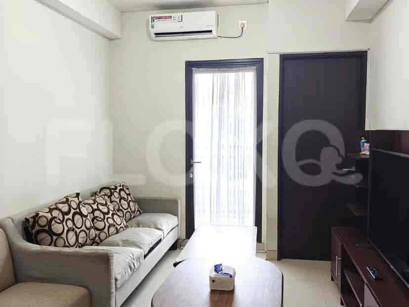 The living room reveals an air conditioner, sofa, and dark brown doors with sheer curtains.