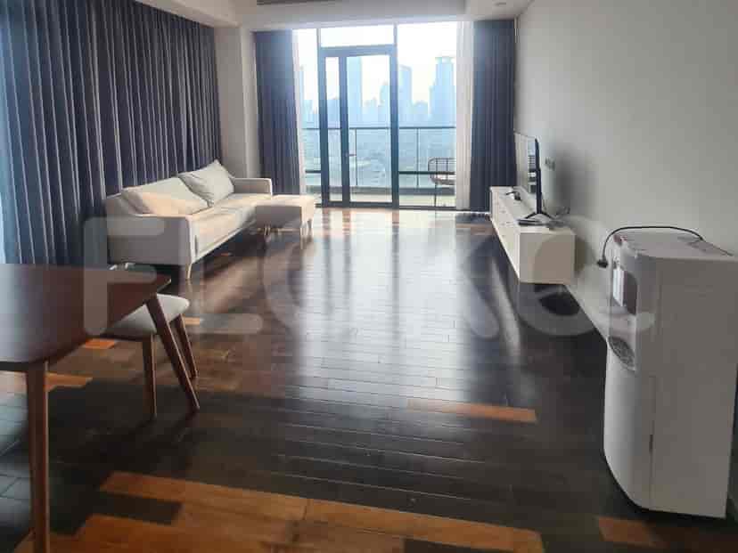 Spacious living room with city views and contemporary furnishings.