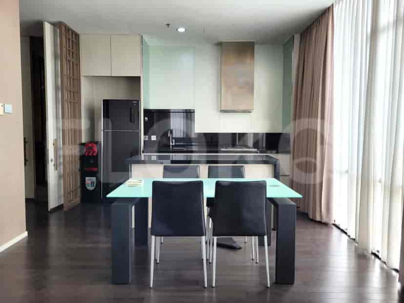 Modern kitchen with a dining area and a black refrigerator.