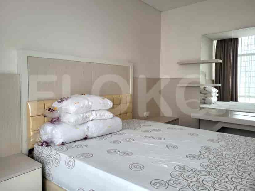 Bedroom with a double bed, neutral walls, and wooden flooring.