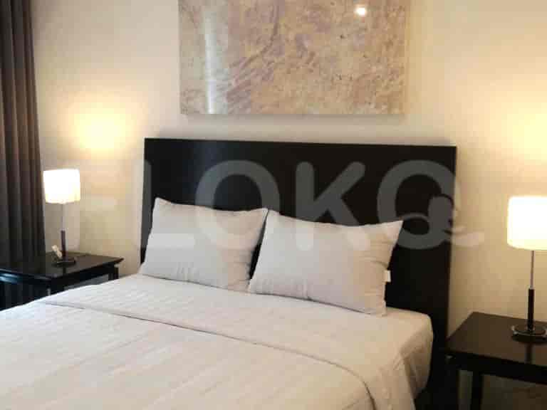 Modern bedroom with a double bed, side tables, and artwork.
