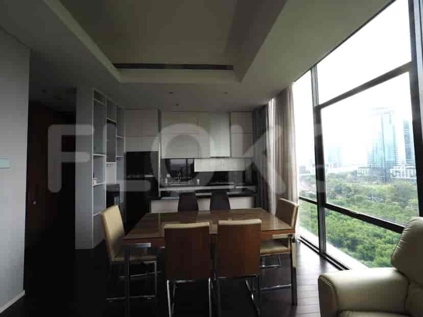 Modern kitchen area with a dining table and city views.