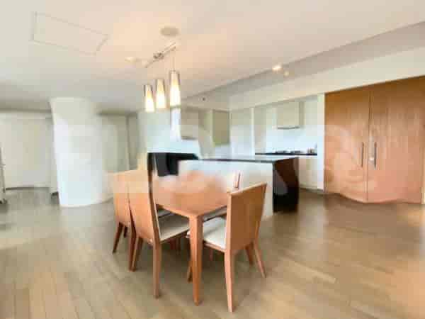 A dining area with a table and chairs adjacent to a kitchen.