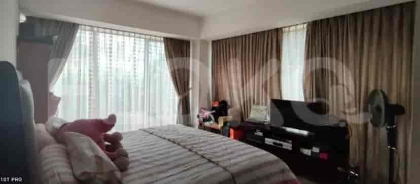 A well-lit bedroom with a large window, bed, and curtains.