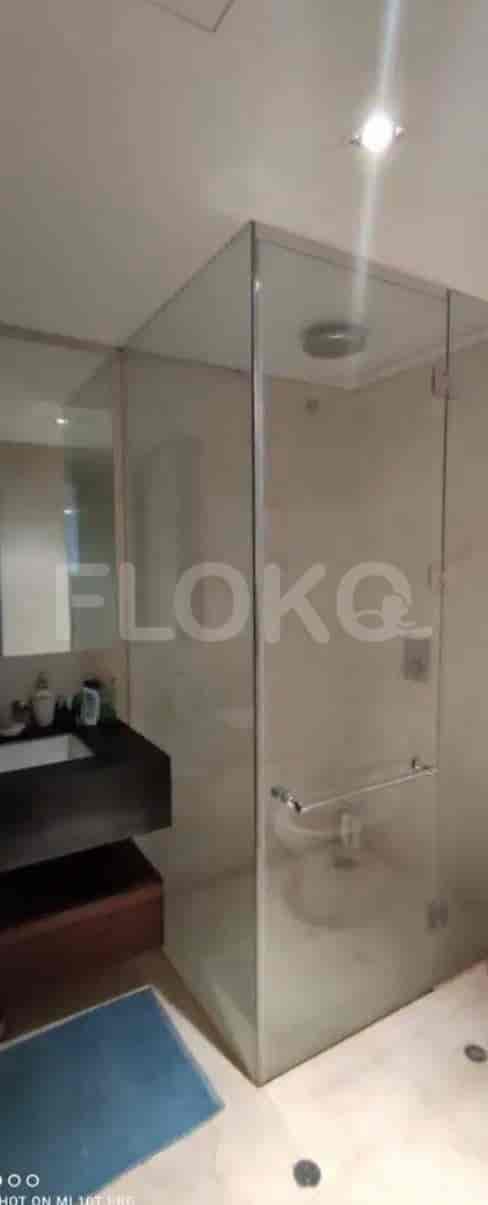 A modern bathroom with a glass-enclosed shower.