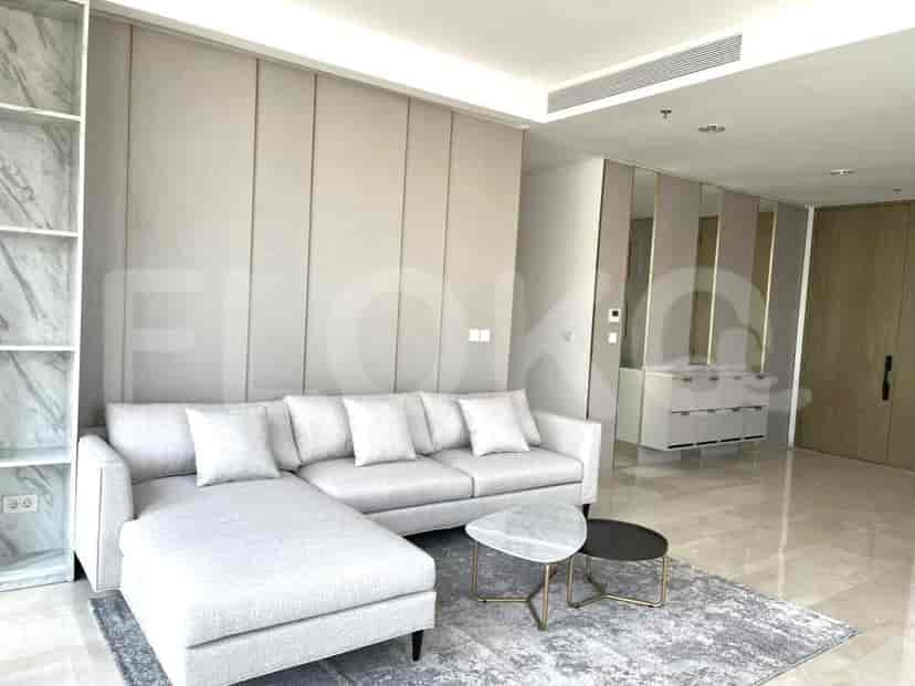 A modern living room featuring a grey L-shaped sofa, marble coffee tables, and an open-plan design.