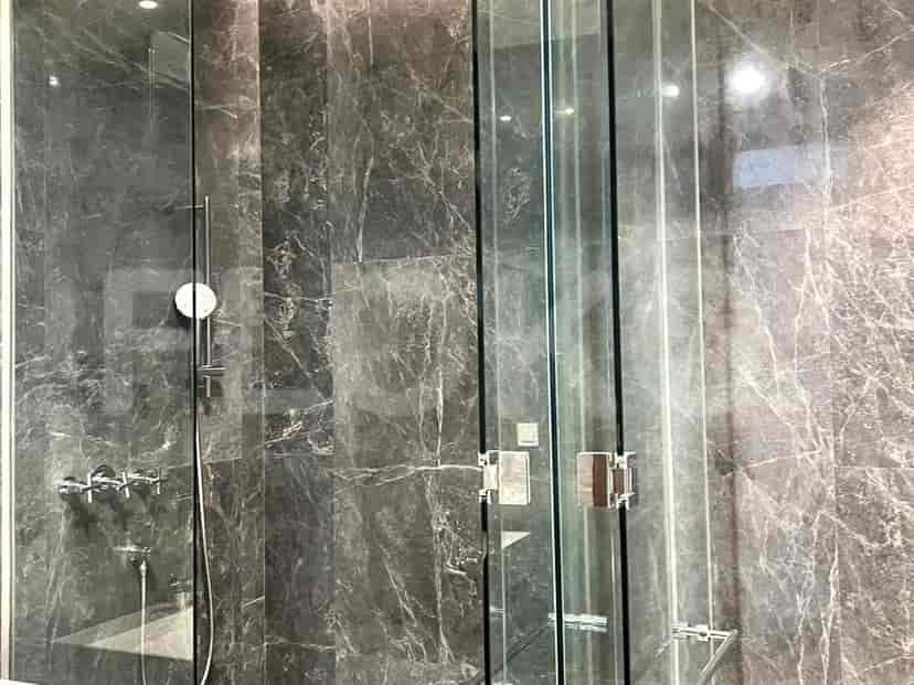 A bathroom with a toilet and shower.