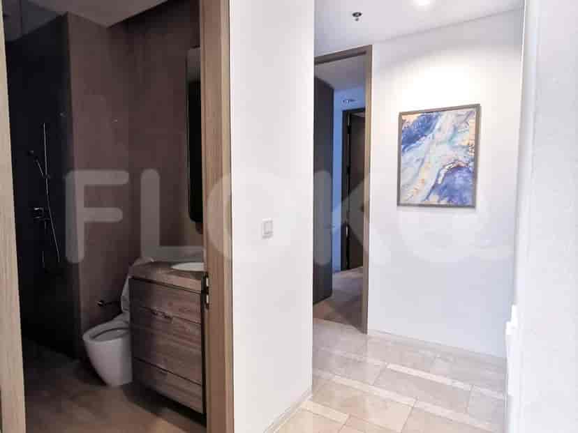 Bathroom entrance with vanity and toilet, next to the bedroom.