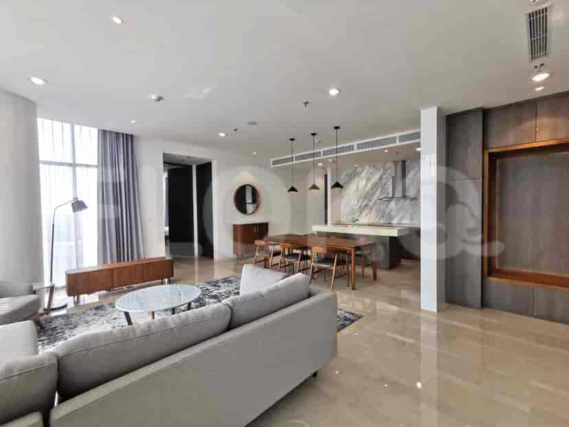 A bedroom with a wooden bed, artwork, and a view of the city.