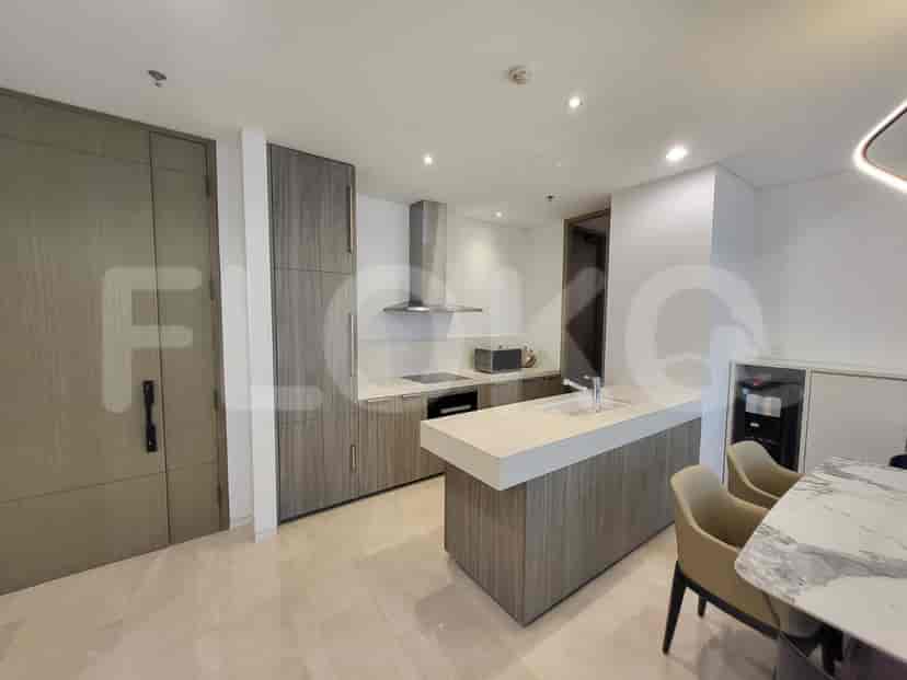 Modern kitchen with wooden cabinets, integrated appliances and a breakfast bar.