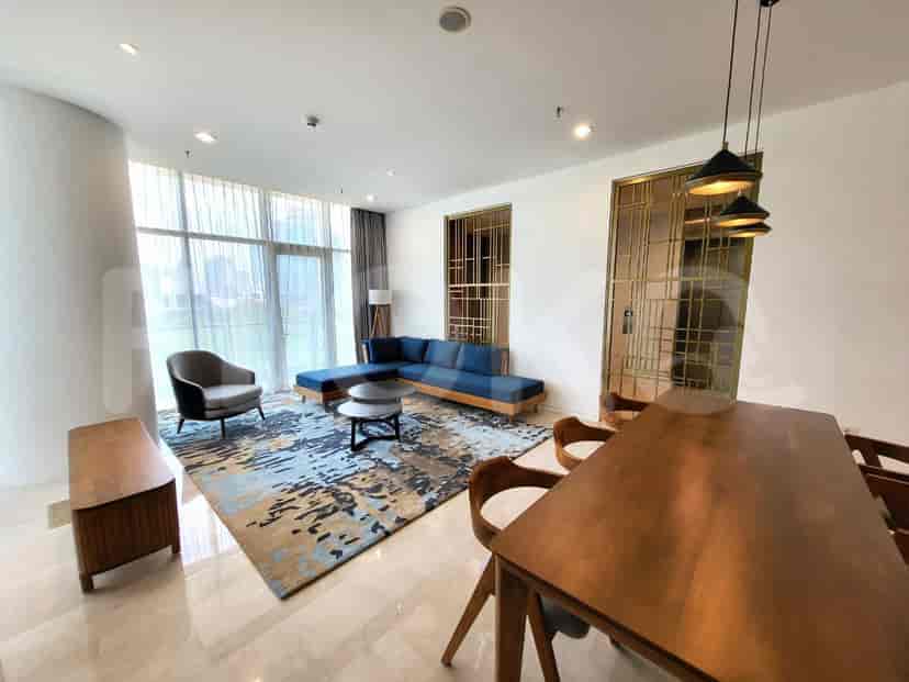 Another view of the bedroom with a desk, chair, and a large mirror.