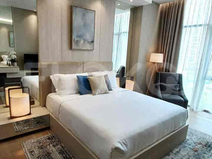 Bedroom featuring a bed, bedside tables, and stylish decor.