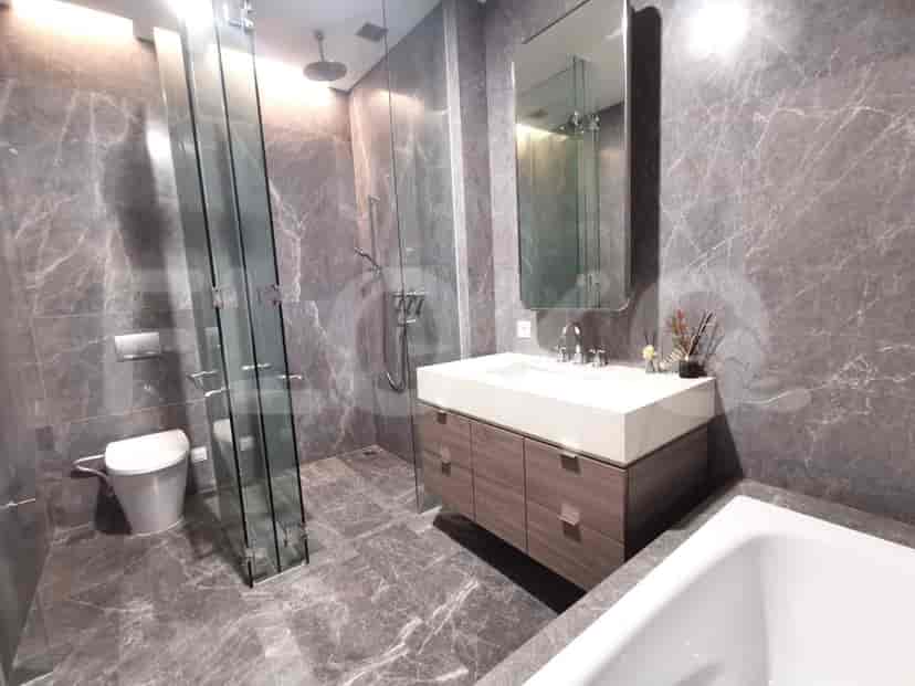 Modern bathroom with a glass-enclosed shower, bathtub, and stylish vanity.