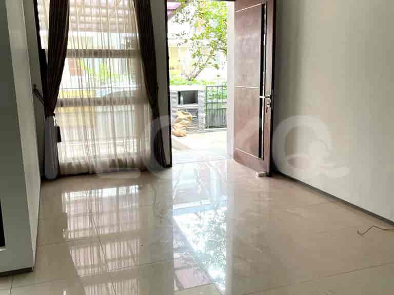 An entrance view with a polished tiled floor and an open doorway leading to an outdoor area.