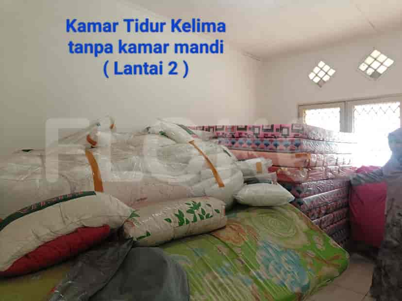 A bedroom with multiple mattresses stacked, indicating a room possibly for storing beds.