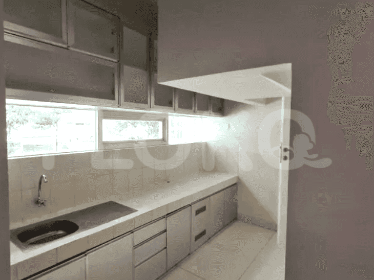A compact kitchen area featuring upper and lower cabinets, a stainless steel sink, and a countertop.