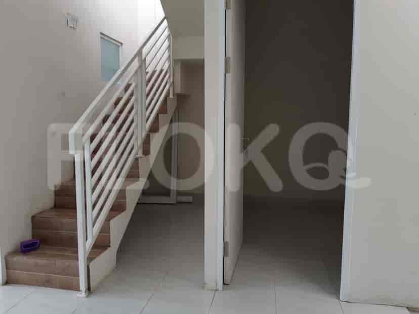 A staircase leading to the upper floor with a door.