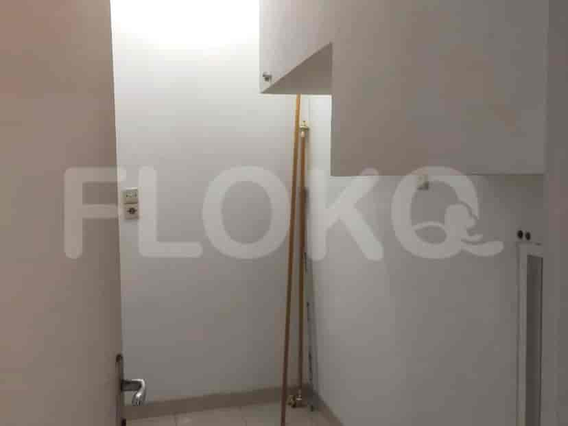 Ruangan kecil dengan lantai berubin dan pintu.