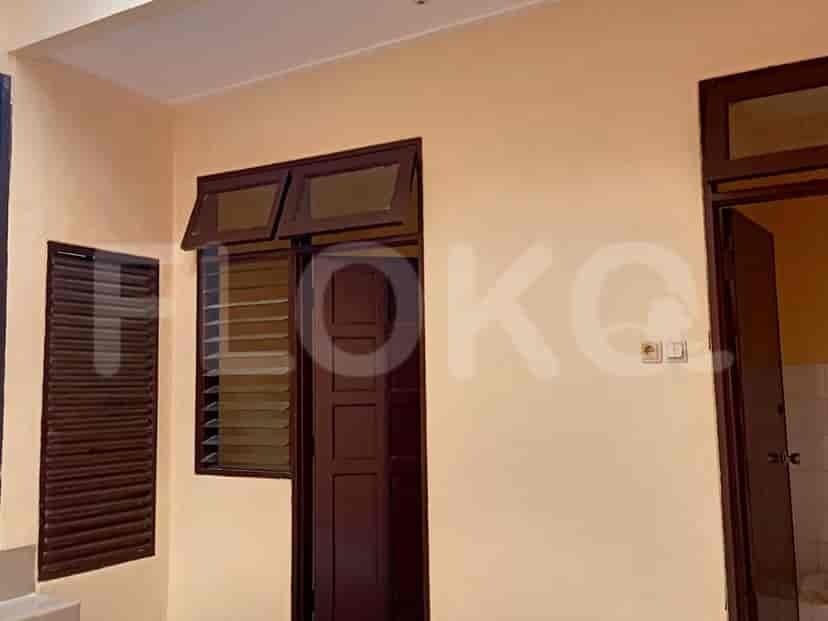 Sebuah ruangan dengan jendela dan kusen pintu coklat dan jendela berbingkai coklat.