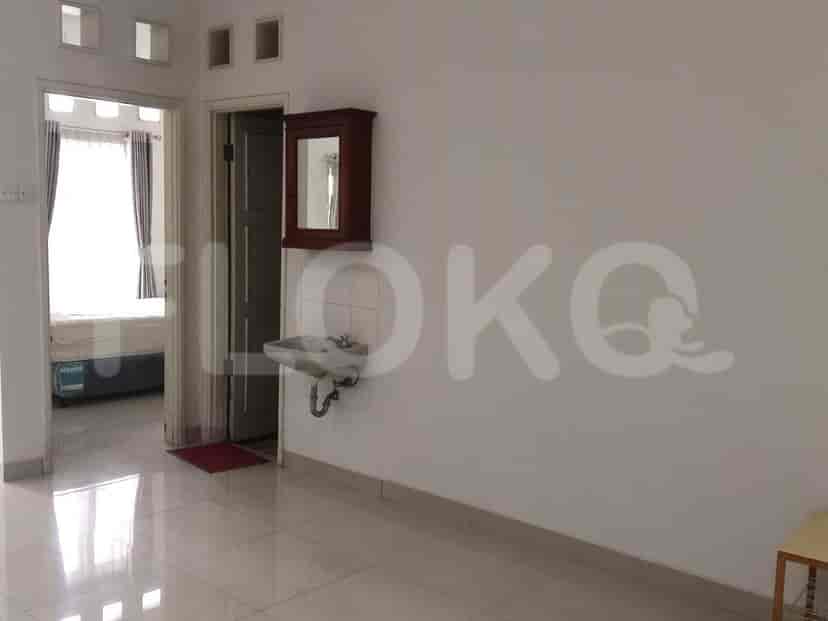 An entryway with a sink, mirror, and a door leading to the bedroom.