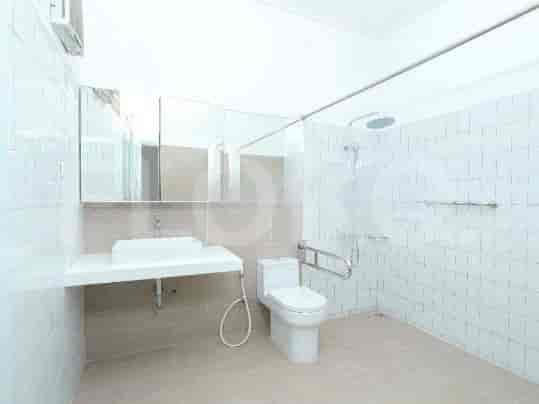 A modern bathroom with a white vanity, a walk-in shower, and a western-style toilet.