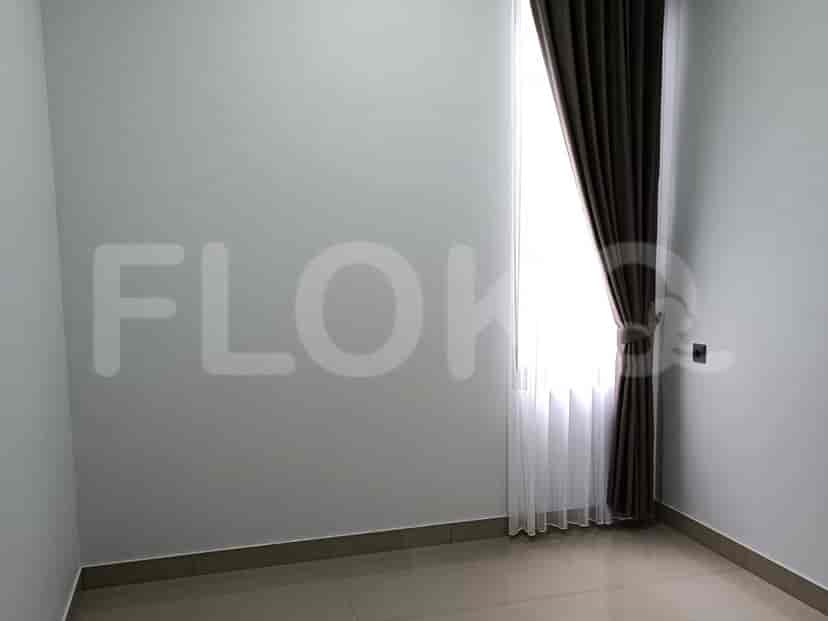 A bright room with a window and white walls.