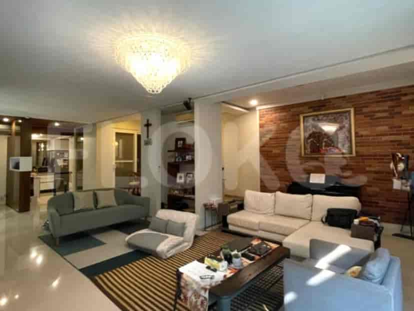 A living room featuring a white sofa, exposed brick wall, and a piano.