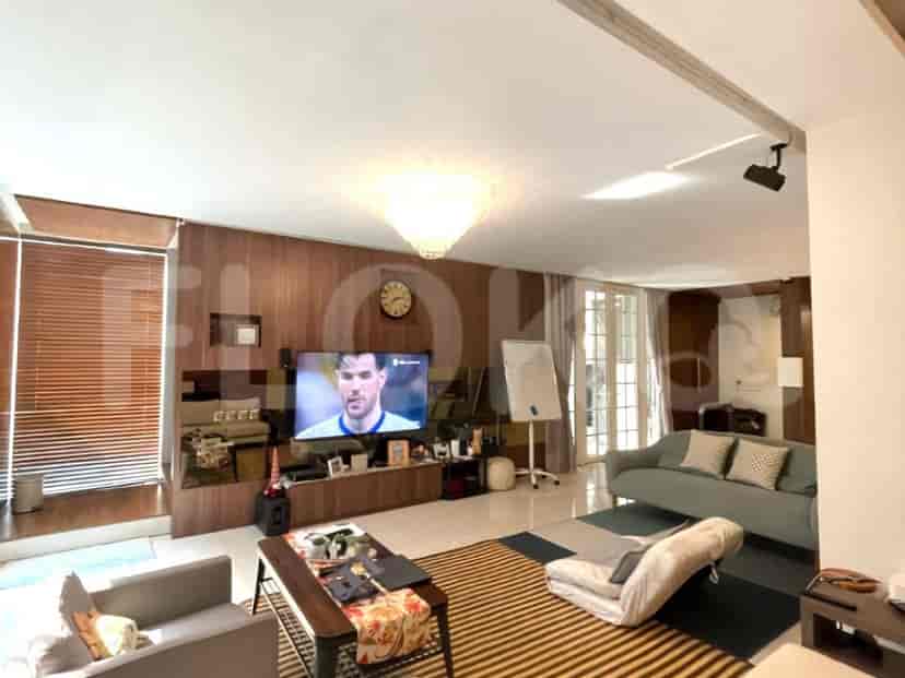 A spacious living room with a television, sofa, and decorative lighting.