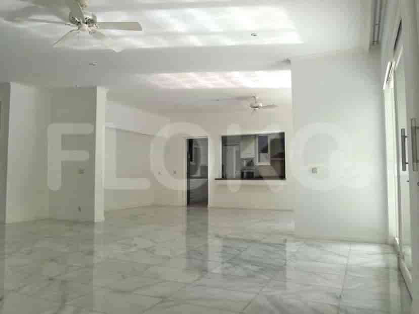 An open-plan living area with a kitchen pass-through, large windows, and marble flooring.