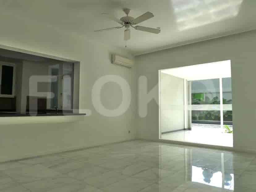 A living area with a pass-through to the kitchen and large windows.