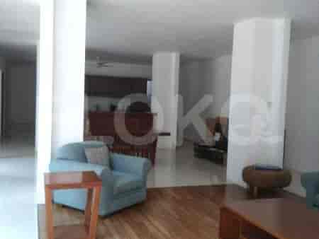 Living area with a kitchen in the background.