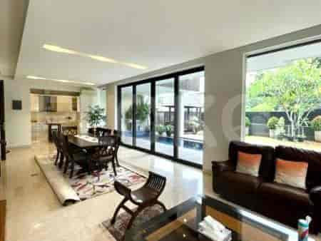 A spacious living room connected to a modern kitchen with sliding glass doors leading to the backyard.