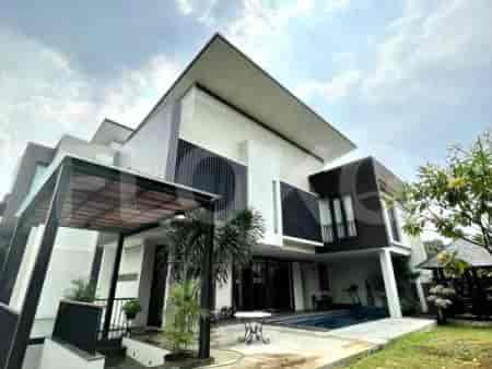 An exterior view of a modern villa with a swimming pool, a gazebo, and landscaped gardens.