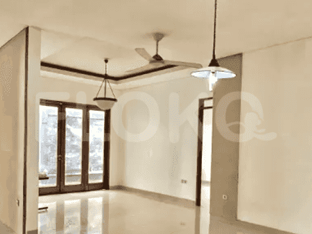 Spacious living room featuring large windows, light-colored walls, and a ceiling fan.