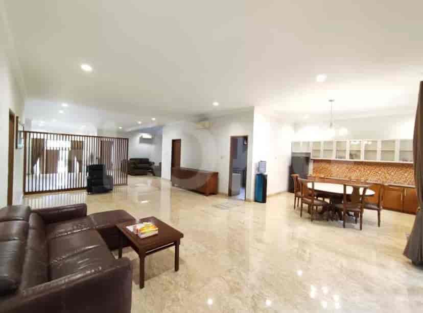 A large open-plan living space with a kitchen, a dining area, and marble flooring.