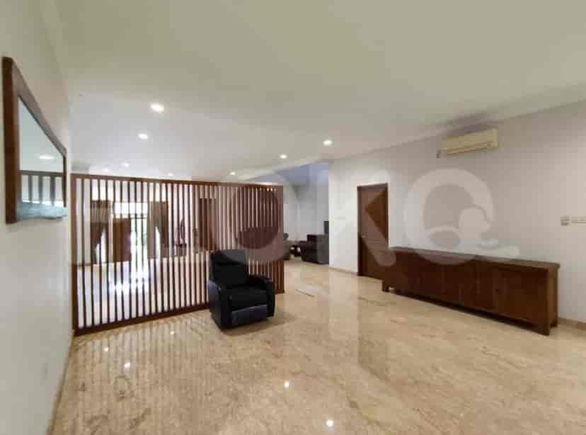 A living room area with marble flooring, a black recliner, and wooden accents.